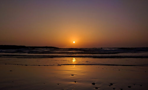 View of calm beach at sunset