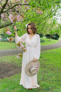 Woman holding flower in park