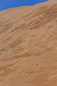 Sand dunes in desert against sky