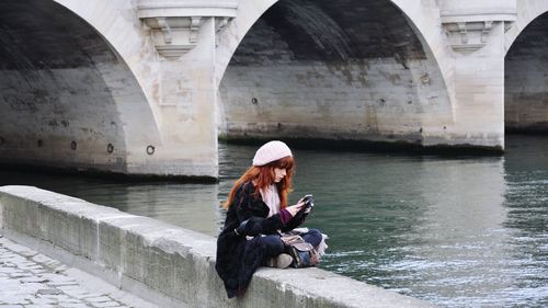 Young woman sitting outdoors