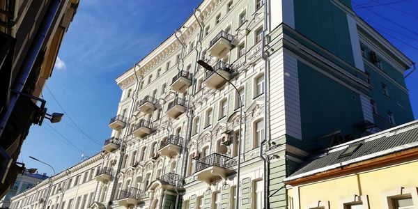 Low angle view of buildings against clear blue sky