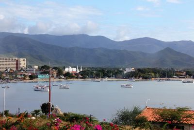 Scenic view of sea and mountains against sky