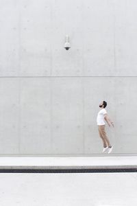 Full length of man jumping on street