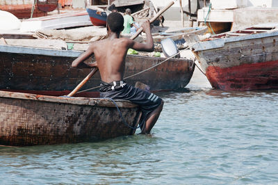 Full length of shirtless man in sea