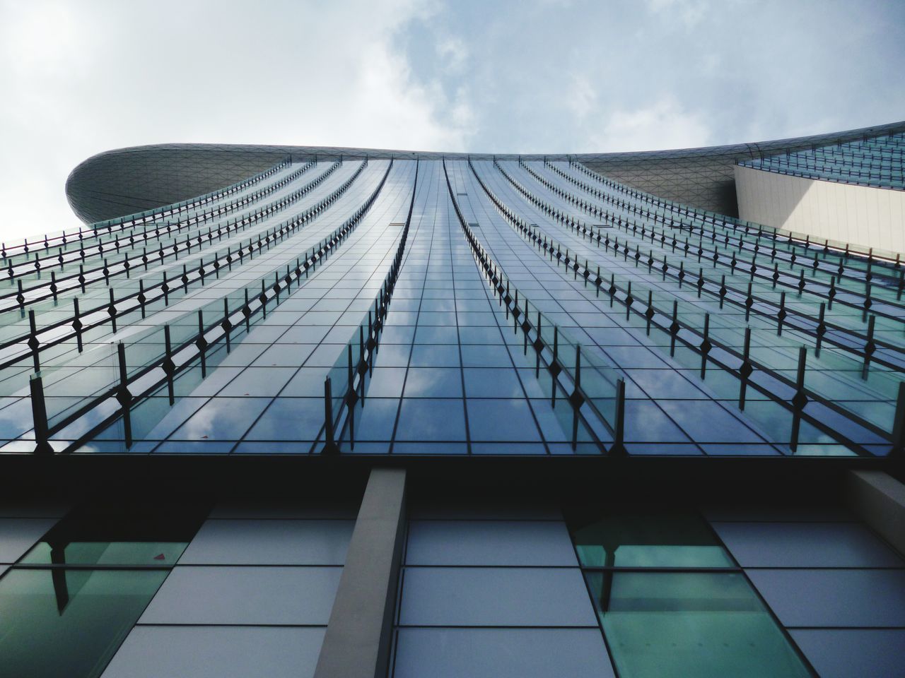 architecture, building exterior, built structure, low angle view, modern, office building, sky, building, city, glass - material, skyscraper, reflection, tall - high, day, tower, window, outdoors, no people, cloud, architectural feature