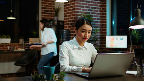 Young woman using laptop at office