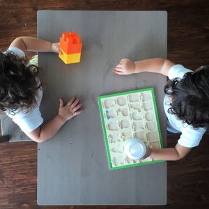 Directly above view of kids with toys on table