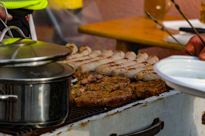 Close-up of meat on barbecue grill at kitchen