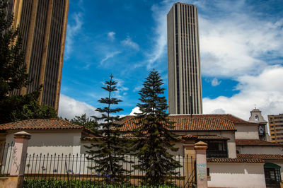 Low angle view of building against cloudy sky