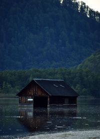 House by lake against mountain