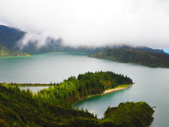 Scenic view of lake and mountains against sky