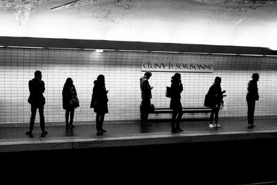 Full length of woman walking on railing