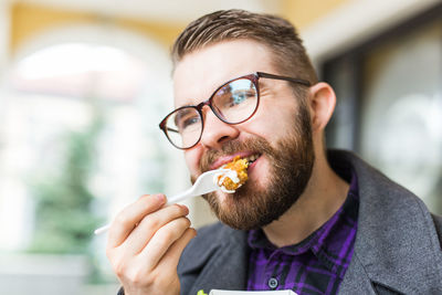 Portrait of man eating corn outdoors