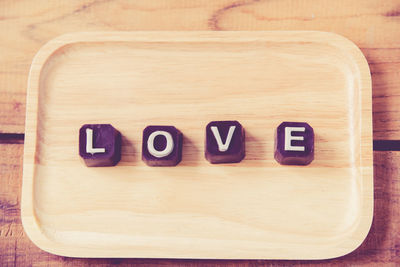 Close-up of love text on chocolates in tray