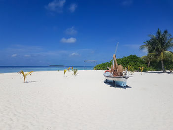 Panoramic view of people on beach against sky