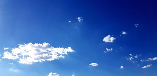 Low angle view of blue sky on sunny day