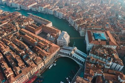 High angle view of bridge over river amidst buildings