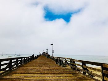 Pier over sea against sky