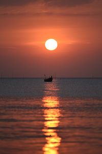 Scenic view of sea against orange sky