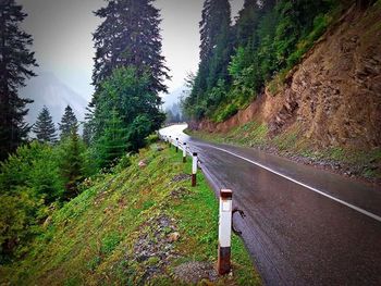 Empty road along countryside landscape