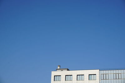 Low angle view of building against blue sky