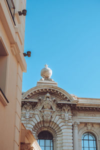 Low angle view of building against clear blue sky