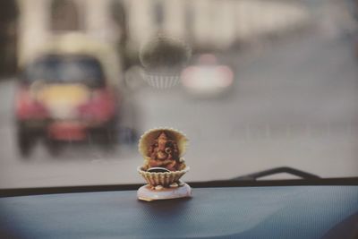 Ganesha idol on dashboard in car