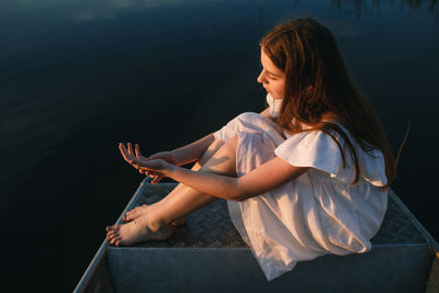 Portrait of young woman sitting on boat