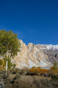 Scenic view of snowcapped mountains against clear blue sky