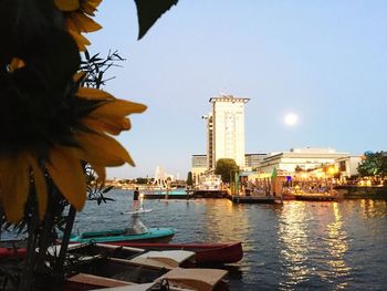 Boats in city against clear sky