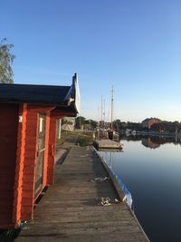 Pier amidst buildings against clear sky