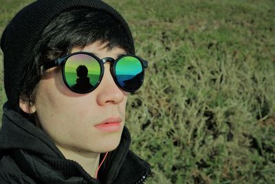 Close-up portrait of young man wearing sunglasses