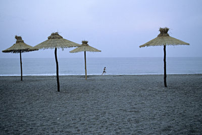 Parasols on beach against sky