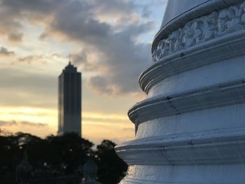 Buildings against cloudy sky during sunset