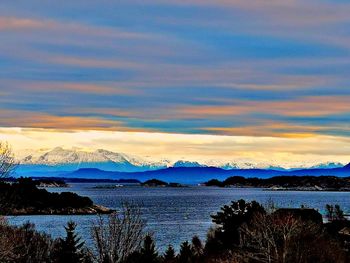 Scenic view of lake against sky during sunset