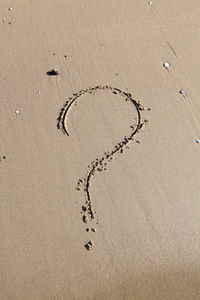 High angle view of heart shape on sand at beach