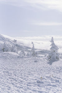 Scenic view of snow covered land against sky