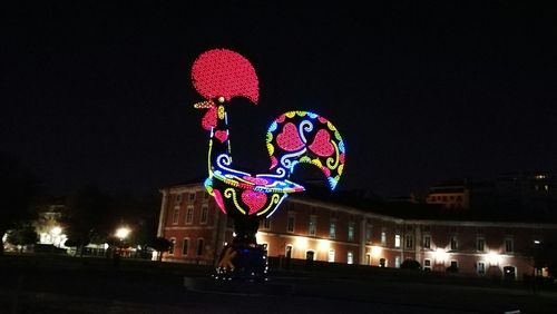 Low angle view of illuminated lights against sky at night