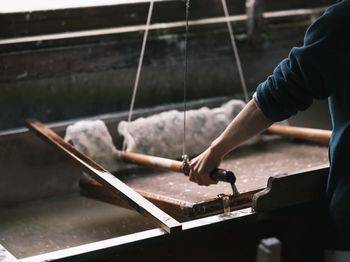 Midsection of man working at workshop