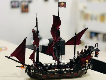Close-up of toys against boat in water