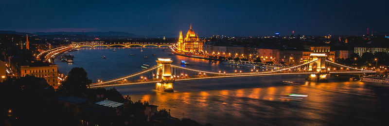 Suspension bridge over river at night