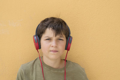 Portrait of young boy listening music on headphones