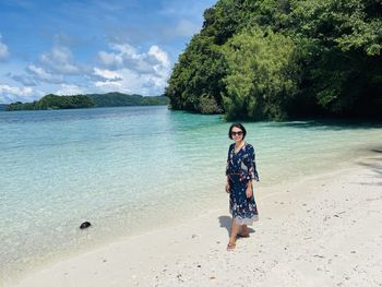 Rear view of woman standing at beach