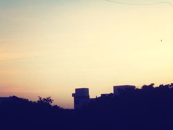 Low angle view of building against sky at sunset