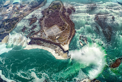 High angle view of rocks on sea shore