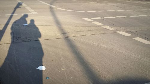 High angle view of people shadow on street
