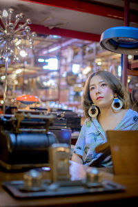 Portrait of a young woman sitting on table