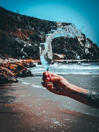 Person holding umbrella splashing water