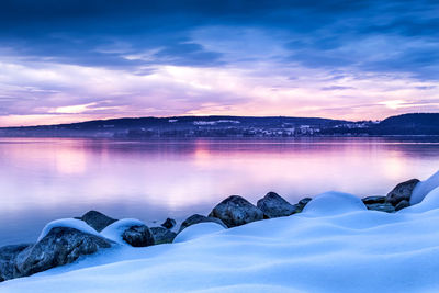 Scenic view of lake against sky during winter