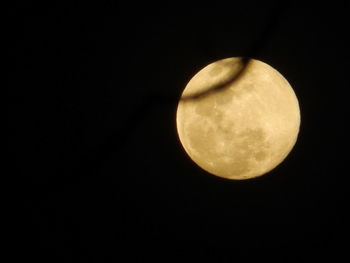 Low angle view of full moon against clear sky at night